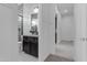Stylish bathroom featuring a black vanity, marble countertop, and modern tiled shower, plus views of the hallway at 2219 E Galileo Dr, Gilbert, AZ 85298