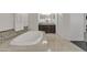 This spacious bathroom offers a soaking tub, and dual vanities for a spa like experience at 2219 E Galileo Dr, Gilbert, AZ 85298