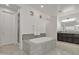 This spacious bathroom has a marble-clad soaking tub, a shower, and a double sink vanity at 2219 E Galileo Dr, Gilbert, AZ 85298