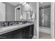 Stylish bathroom with double vanity, marble countertops, grey walls, tiled shower, and modern fixtures at 2219 E Galileo Dr, Gilbert, AZ 85298