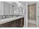 Modern bathroom featuring dual sinks, dark wood cabinets, marble countertop and glass-enclosed shower at 2219 E Galileo Dr, Gilbert, AZ 85298