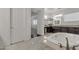 Bright, open bathroom with a marble-clad soaking tub, and dark wood cabinets at 2219 E Galileo Dr, Gilbert, AZ 85298