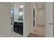 A glimpse into a well-lit bathroom with a dark vanity and modern fixtures at 2219 E Galileo Dr, Gilbert, AZ 85298