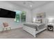 Bright bedroom with a large window, ceiling fan, TV, and stylish decor at 2219 E Galileo Dr, Gilbert, AZ 85298