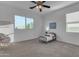 Bright bedroom with a ceiling fan, a large window providing natural light, and neutral carpeting at 2219 E Galileo Dr, Gilbert, AZ 85298
