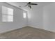 Spacious bedroom with neutral walls, carpeting, ceiling fan, and ample natural light at 2219 E Galileo Dr, Gilbert, AZ 85298