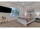 Cozy bedroom featuring a queen-size bed, TV, neutral colors, and natural light at 2219 E Galileo Dr, Gilbert, AZ 85298