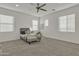 Spacious bedroom with neutral walls, carpeted floor, ceiling fan and natural light from multiple windows at 2219 E Galileo Dr, Gilbert, AZ 85298