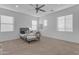 Large bedroom featuring neutral walls, carpeting, ceiling fan, and multiple large windows at 2219 E Galileo Dr, Gilbert, AZ 85298