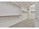 Well-organized walk-in closet with custom shelving and wooden rods at 2219 E Galileo Dr, Gilbert, AZ 85298