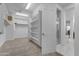 Walk-in closet leading into the bathroom with a glass enclosed shower and tiled flooring at 2219 E Galileo Dr, Gilbert, AZ 85298