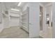 Bright walk-in closet leading to a bathroom with ample shelving and convenient access at 2219 E Galileo Dr, Gilbert, AZ 85298