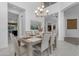 Elegant dining room with modern chandelier, a grand dining table set for a meal, and bright, open feel at 2219 E Galileo Dr, Gilbert, AZ 85298