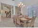 Open concept dining room with neutral decor, a modern chandelier, and access to the staircase at 2219 E Galileo Dr, Gilbert, AZ 85298