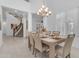 Elegant dining room featuring an ornate chandelier and adjacent staircase at 2219 E Galileo Dr, Gilbert, AZ 85298