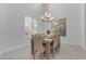 Cozy dining room with vaulted ceilings, modern light fixture and natural light creating a comfortable space at 2219 E Galileo Dr, Gilbert, AZ 85298