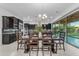Open-concept dining room with elegant lighting adjacent to modern kitchen at 2219 E Galileo Dr, Gilbert, AZ 85298