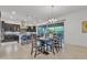 Dining room featuring a table adjacent to the kitchen with large sliding glass doors leading to the outdoors at 2219 E Galileo Dr, Gilbert, AZ 85298