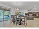 Open dining area with modern table set and view of the living room and outdoor pool at 2219 E Galileo Dr, Gilbert, AZ 85298