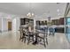 Open-concept kitchen and dining area features dark wood cabinets and a modern chandelier above the table at 2219 E Galileo Dr, Gilbert, AZ 85298