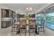 Open dining room with modern lighting, stylish table setting, and sliding glass doors to the backyard at 2219 E Galileo Dr, Gilbert, AZ 85298