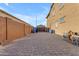 Backyard featuring a long driveway, brick wall, and storage space at 2219 E Galileo Dr, Gilbert, AZ 85298
