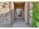 Inviting front entrance with stone accents and a covered walkway, leading to a welcoming front door at 2219 E Galileo Dr, Gilbert, AZ 85298
