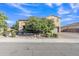 Beautiful home with stone accents, mature trees, and a well-manicured front yard at 2219 E Galileo Dr, Gilbert, AZ 85298