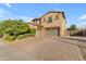 Spacious two-story home with a three-car garage and manicured front yard at 2219 E Galileo Dr, Gilbert, AZ 85298