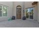Beautiful arched doorway adorned with potted plants and featuring a decorative wreath offers a warm welcome to the home at 2219 E Galileo Dr, Gilbert, AZ 85298