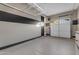 Spacious garage with epoxy flooring, storage racks, and ample room for vehicles and projects at 2219 E Galileo Dr, Gilbert, AZ 85298