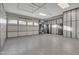 Spacious garage with custom cabinets, epoxy floor, and overhead storage at 2219 E Galileo Dr, Gilbert, AZ 85298