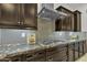 Close up of elegant kitchen with granite counters, tiled backsplash, and stainless steel appliances at 2219 E Galileo Dr, Gilbert, AZ 85298