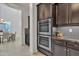 Modern kitchen with stainless steel appliances, dark wood cabinets, and stylish backsplash at 2219 E Galileo Dr, Gilbert, AZ 85298