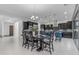 Open-concept kitchen features modern black cabinetry, large island, and adjacent dining area, all with bright, natural light at 2219 E Galileo Dr, Gilbert, AZ 85298