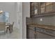 Kitchen area with granite counters, custom cabinets and view to the dining area at 2219 E Galileo Dr, Gilbert, AZ 85298