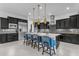 Modern kitchen featuring a large island, stainless steel appliances, and sleek black cabinetry at 2219 E Galileo Dr, Gilbert, AZ 85298