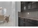Kitchen area featuring custom black cabinetry, and a view to the dining room at 2219 E Galileo Dr, Gilbert, AZ 85298