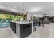 Open concept kitchen with oversized island, dining area, and sliding glass doors at 2219 E Galileo Dr, Gilbert, AZ 85298