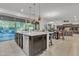 Open concept kitchen with large island, stainless appliances, and access to the outdoor area at 2219 E Galileo Dr, Gilbert, AZ 85298