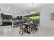 Bright eat-in kitchen boasts modern black cabinetry, large island, and sliding doors that open to the backyard at 2219 E Galileo Dr, Gilbert, AZ 85298