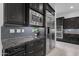 Modern kitchen featuring stainless steel appliances, dark cabinets and granite countertops at 2219 E Galileo Dr, Gilbert, AZ 85298