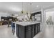 Kitchen island featuring black cabinetry, stainless steel dishwasher and white countertops at 2219 E Galileo Dr, Gilbert, AZ 85298