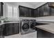 Well-equipped laundry room features modern washer and dryer, built in storage and sink at 2219 E Galileo Dr, Gilbert, AZ 85298