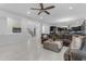 Bright and open living room featuring modern decor, tile floors, and seamless flow to the kitchen area at 2219 E Galileo Dr, Gilbert, AZ 85298