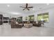 Spacious living room with large sectional sofa, tile flooring and ceiling fan at 2219 E Galileo Dr, Gilbert, AZ 85298