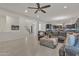 Expansive living room with tiled floors, ceiling fan, and comfortable gray sectional sofa at 2219 E Galileo Dr, Gilbert, AZ 85298