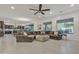 Bright living room with tile floors, a comfortable sectional sofa, and large windows at 2219 E Galileo Dr, Gilbert, AZ 85298