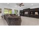 Living room featuring a large sectional sofa, built-in cabinets and tile flooring at 2219 E Galileo Dr, Gilbert, AZ 85298