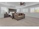 Spacious main bedroom suite includes a ceiling fan, a seating area, and large windows that provide natural light at 2219 E Galileo Dr, Gilbert, AZ 85298